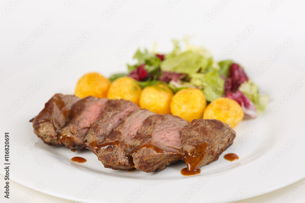 Roasted meat with vegetables on the table