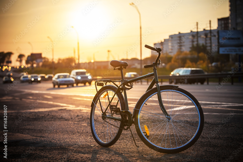 Fototapeta premium Classic city bike on the road at sunset