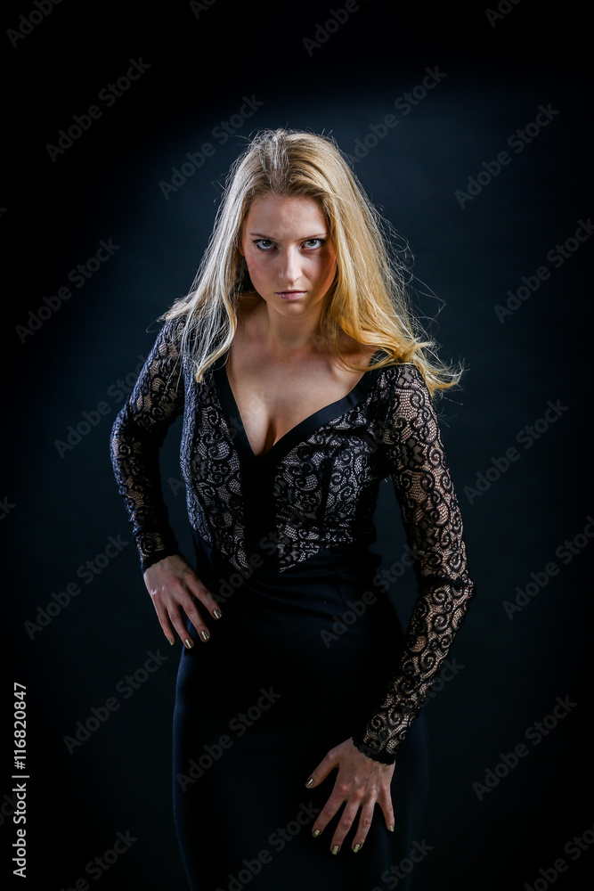 blonde girl on a black background in a dark guipure dress blonde girl on a black background in a dark guipure dress