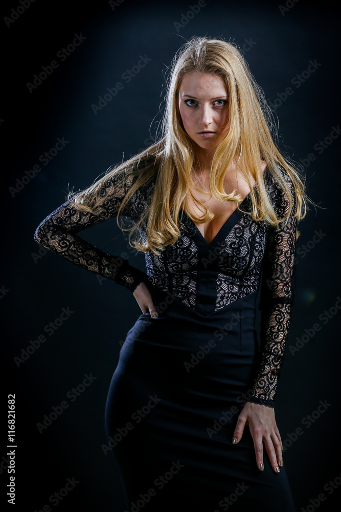 blonde girl on a black background in a dark guipure dress blonde girl on a black background in a dark guipure dress