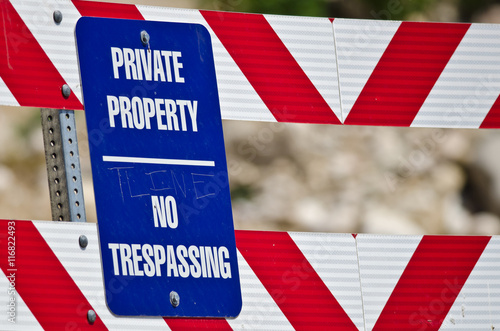 Blue and White Private Property Sign on Construction Barricade photo