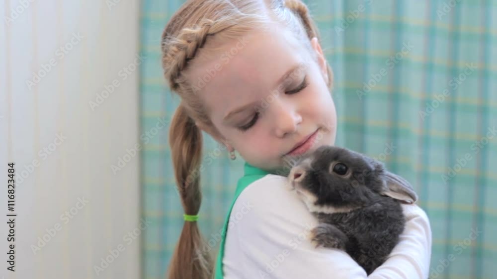 girl with rabbit posing during photo session girl with rabbit posing during photo session