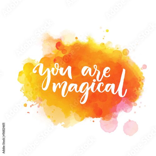 You are magical. Inspiration saying lettering on bright orange watercolor paint stain. Vector phrase for greeting cards, wall art.