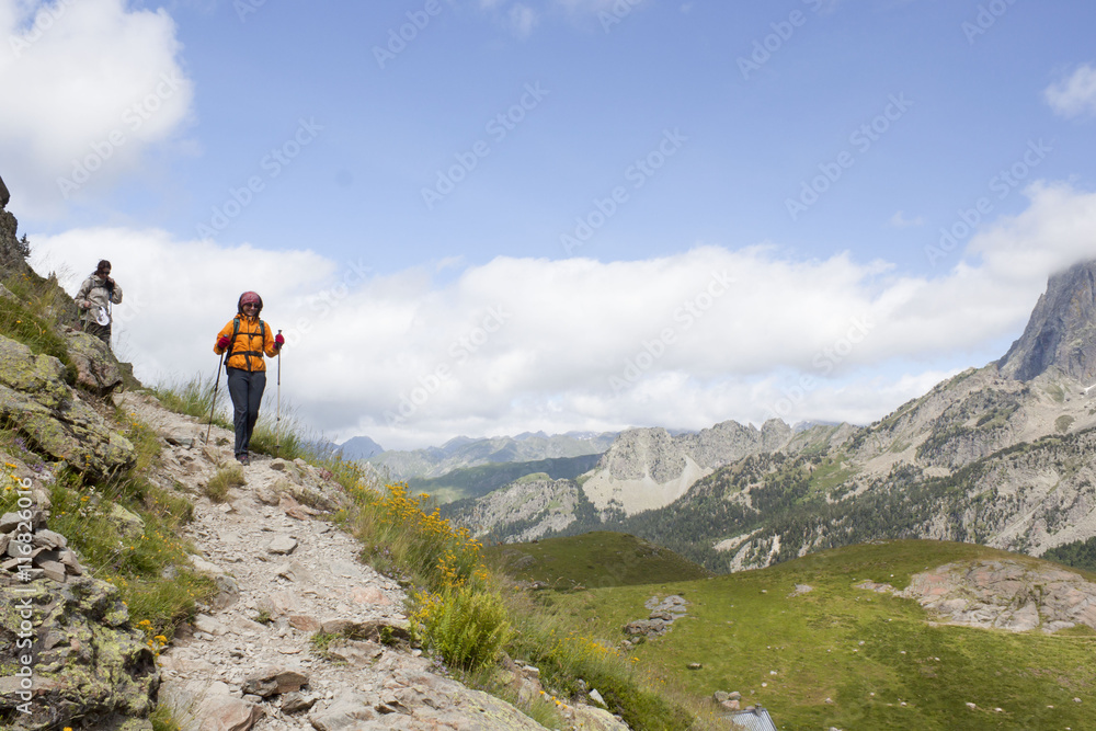 two mountaineers hiking in the high of a mountain in the Pyrenees, France two mountaineers hiking in the high of a mountain in the Pyrenees, France
