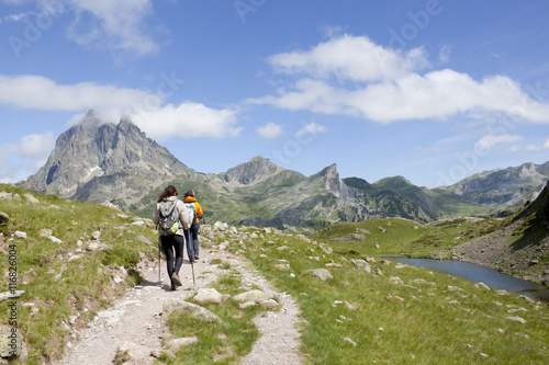 two hiker in front of the Midi d'Ossau and in the Ayous Lakes, Pyrenees, France