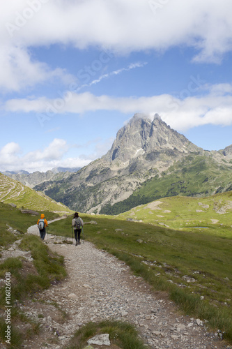 Two girls hiking with the Midi d'Ossau peak behind
