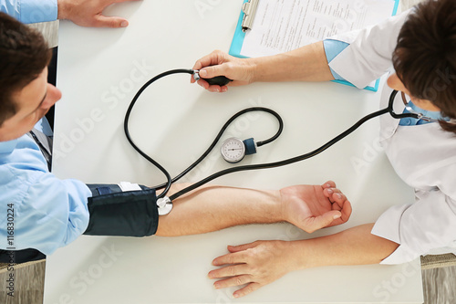 Female doctor measuring man...