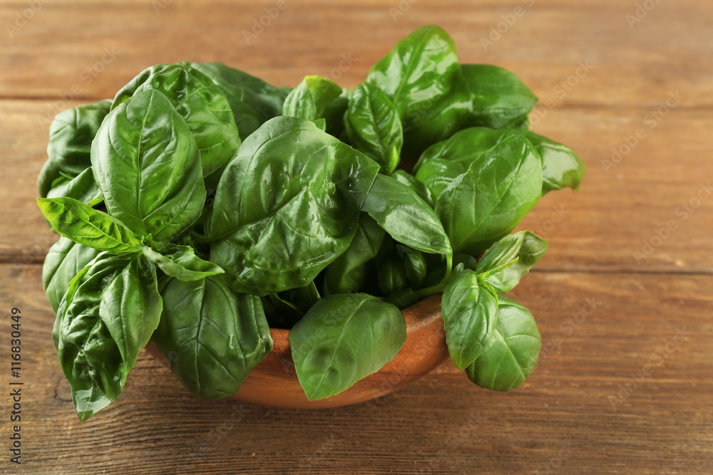 Fresh bunch of basil on wooden table Fresh bunch of basil on wooden table