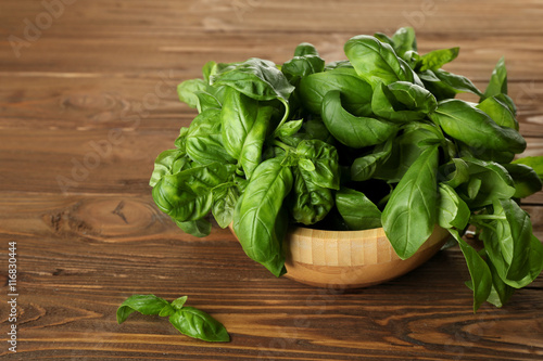Fresh bunch of basil on wooden table