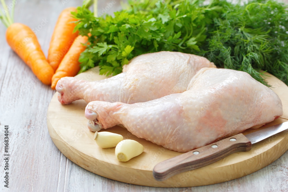 Raw chicken legs with vegetables ready for cooking Raw chicken legs with vegetables ready for cooking