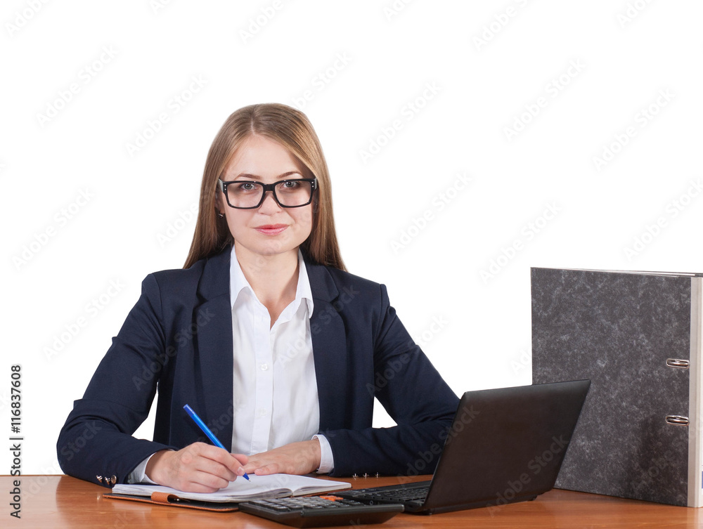Young beautiful business woman in glasses sitting at the table with black laptop or netbook. Isolated on white background. Young beautiful business woman in glasses sitting at the table with black laptop or netbook. Isolated on white background.