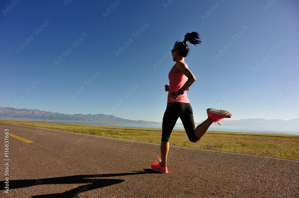 healthy young fitness woman runner running on sunrise seaside trail