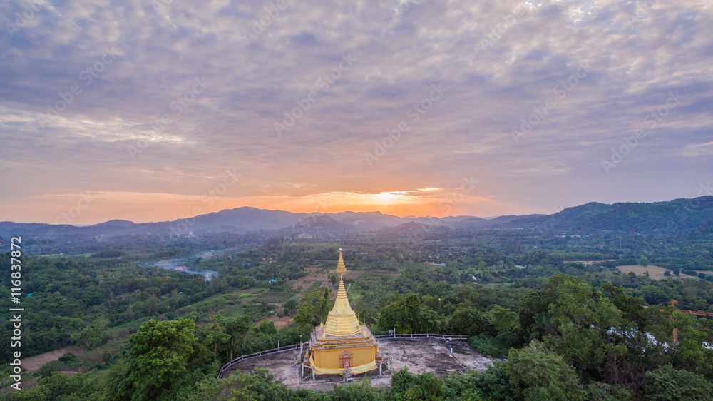 Fototapeta premium Big Buddha statue and golden pagoda on hilltop this temple have several amazing building and famous in thailand.this temple is beside national park. the middle part of Thailand