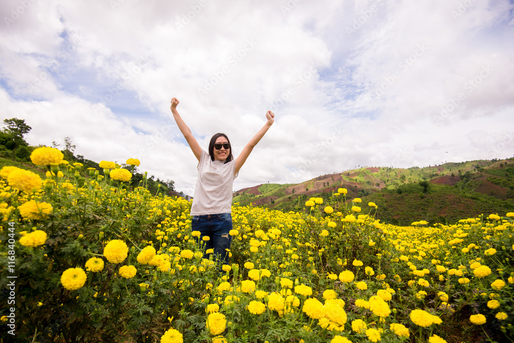 Beautiful Young Woman Outdoors. Enjoy Nature. show hand up with realxing in flower garden in front of the mountain. Beautiful Young Woman Outdoors. Enjoy Nature. show hand up with realxing in flower garden in front of the mountain.