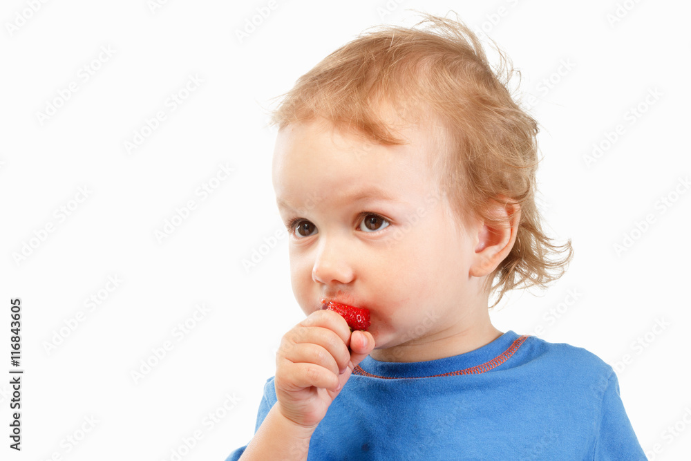 Portrait of a boy eating strawberries, on white background Portrait of a boy eating strawberries, on white background