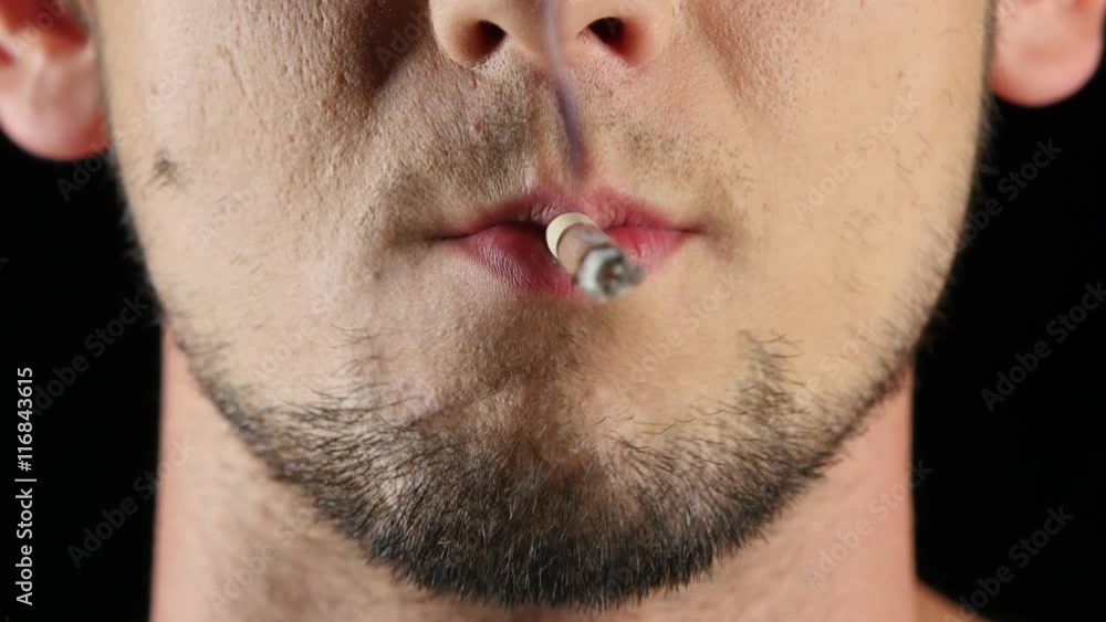 Man smokes a cigarette. Bad habits. Black. Close up Man smokes a cigarette. Bad habits. Black. Close up