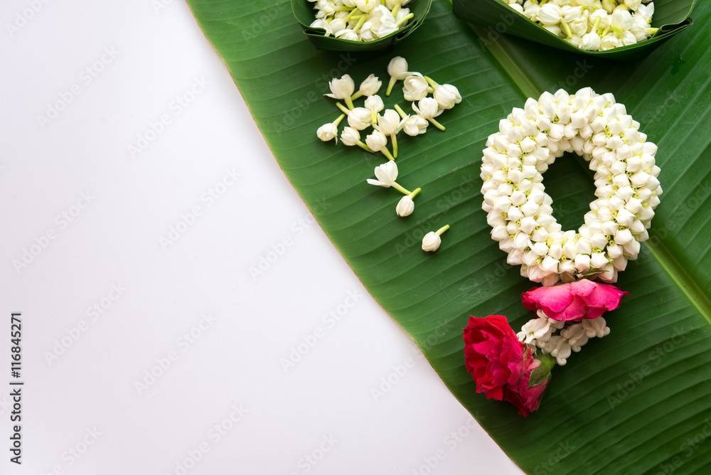 Thai traditional jasmine garland.symbol of Mother's day in thailand on Banana leaf. Thai traditional jasmine garland.symbol of Mother's day in thailand on Banana leaf.