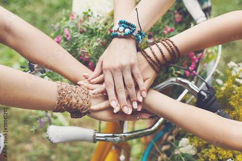 United hands of girlfriends closeup, young girls in boho bracelets © Prostock-studio