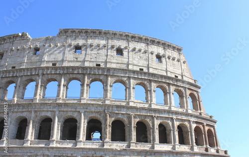 Great Colosseum in Rome, Italy, Europe. Roman Coliseum close-up with clear blue sky.