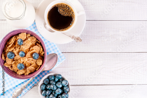 healthy breakfast, coffee cornflakes berries and milk, with text space top view close-up © Irina Sokolovskaya