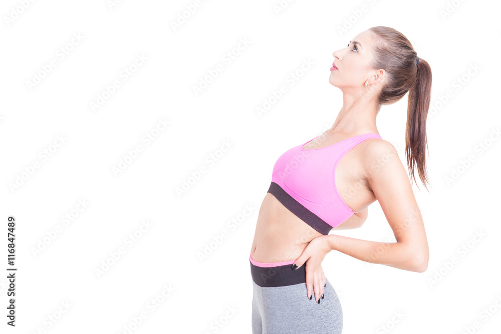 Female trainer stretching her back preparing for workout Female trainer stretching her back preparing for workout