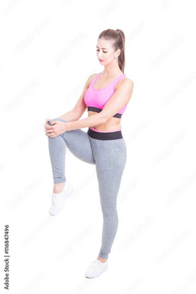 Woman wearing sports wear stretching legs before workout Woman wearing sports wear stretching legs before workout