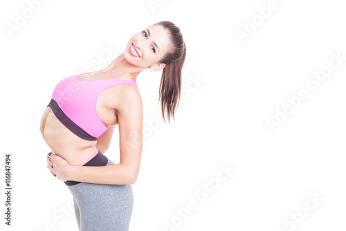 Young woman contortionist posing in unnatural position