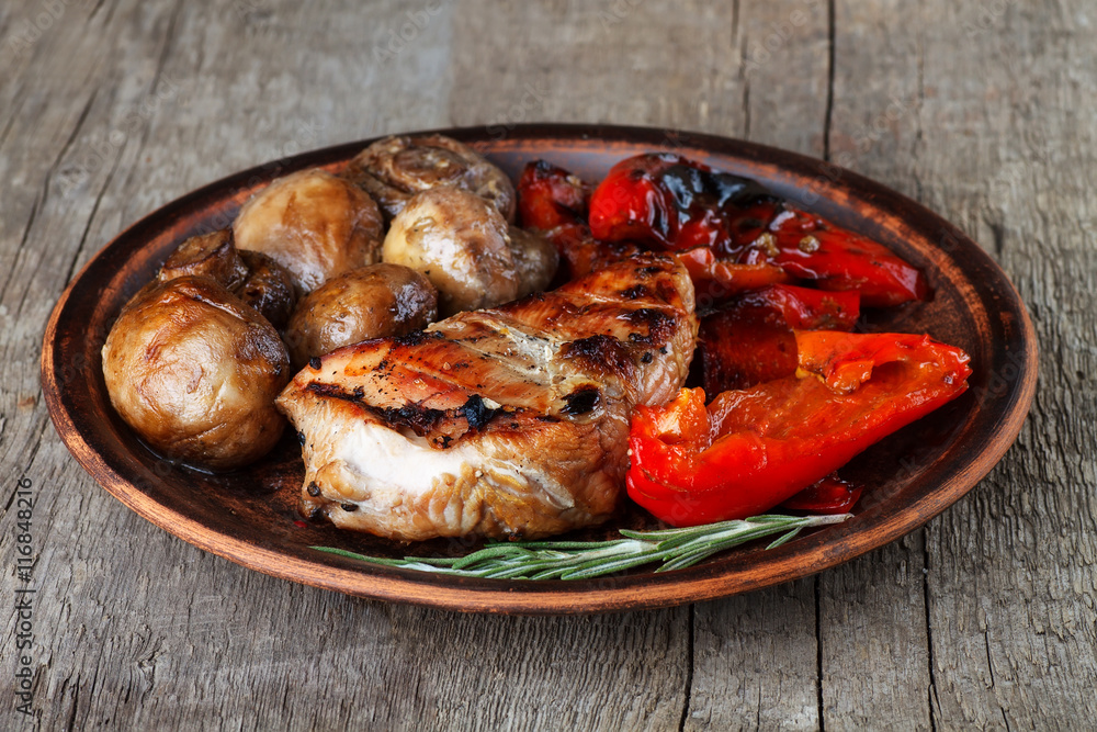 grilled vegetables and meat on the clay plate grilled vegetables and meat on the clay plate