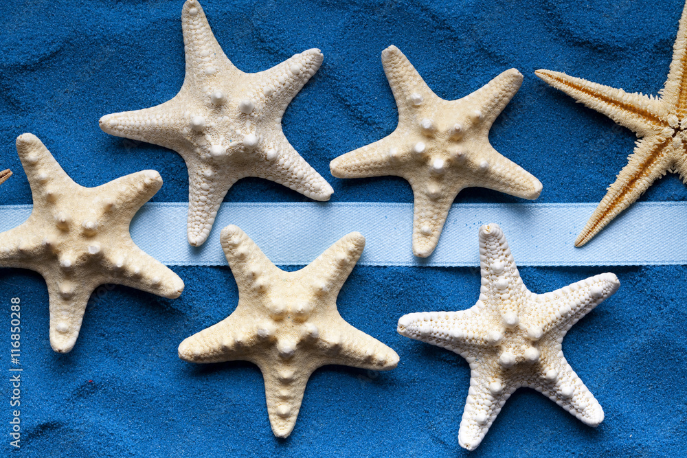 Starfish and ribbon on blue background Starfish and ribbon on blue background