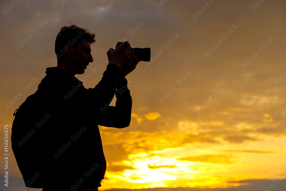 silhouette of photographer taking picture of landscape during sunset silhouette of photographer taking picture of landscape during sunset