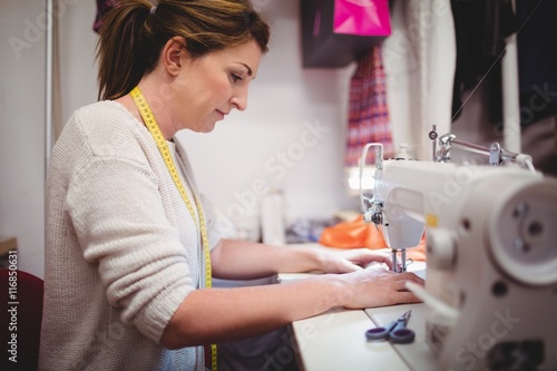 Female dressmaker sewing in the studio