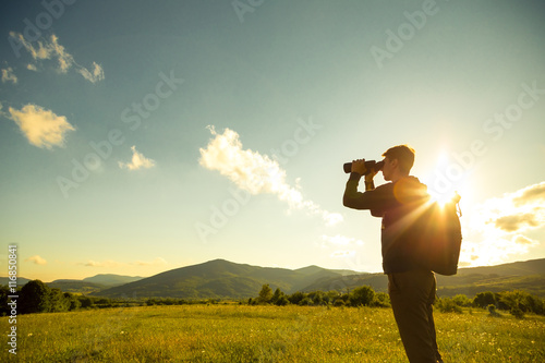 Photography Young Man use of the binocular at forest