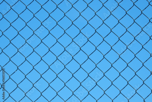 Chain-link fence against blue sky