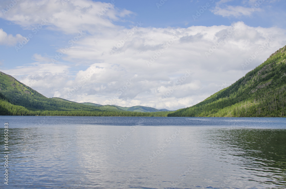 Beautiful landscape of the lake among mountains and the wood
