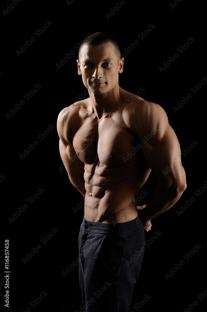 Muscular fitness man on black background