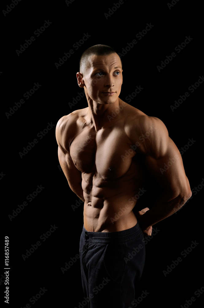 Muscular fitness man on black background