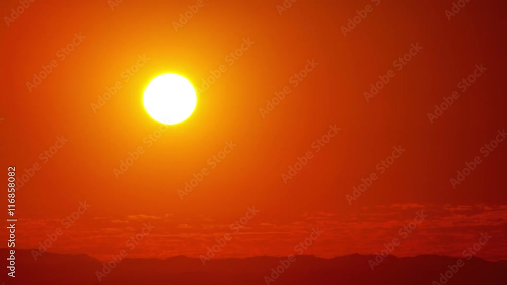 Beautiful time lapse of the sun setting behind the clouds. Beautiful time lapse of the sun setting behind the clouds.