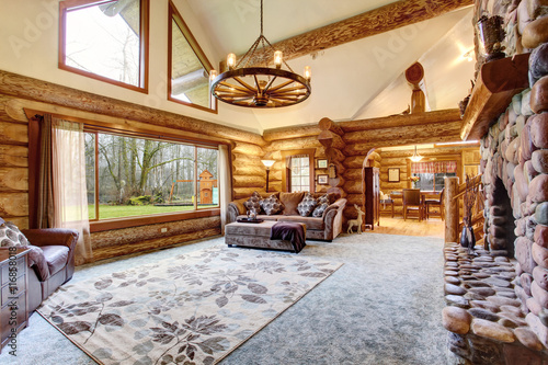 Bright Living room interior in American log cabin house.