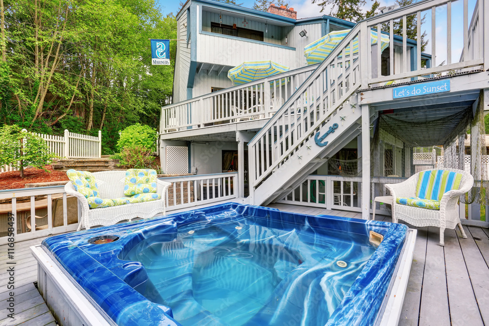 Large marine style home with two level deck. Jacuzzi view