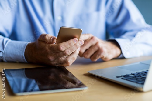 Midsection of man using mobile phone