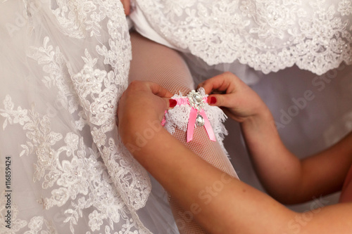 The bridesmaid helps to bride © IVASHstudio