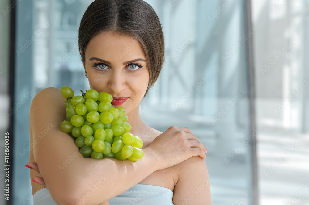 Beautiful turkish woman holding a bunch of grapes Beautiful turkish woman holding a bunch of grapes