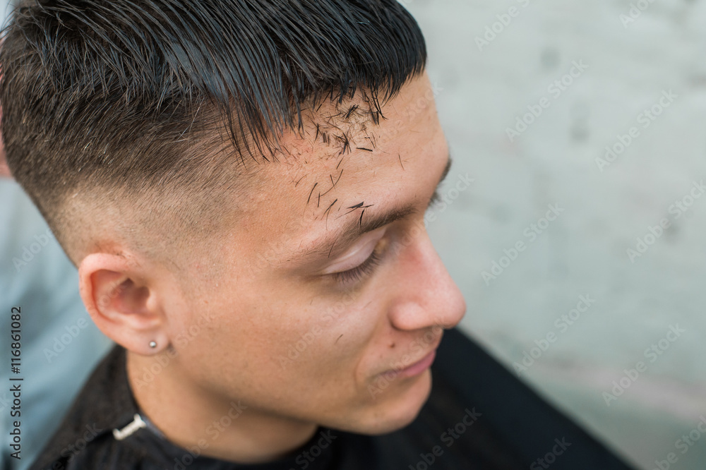close up shot of man getting his hair cut