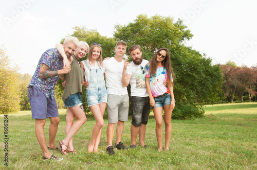 Group of friends having fun in a park on a sunny day