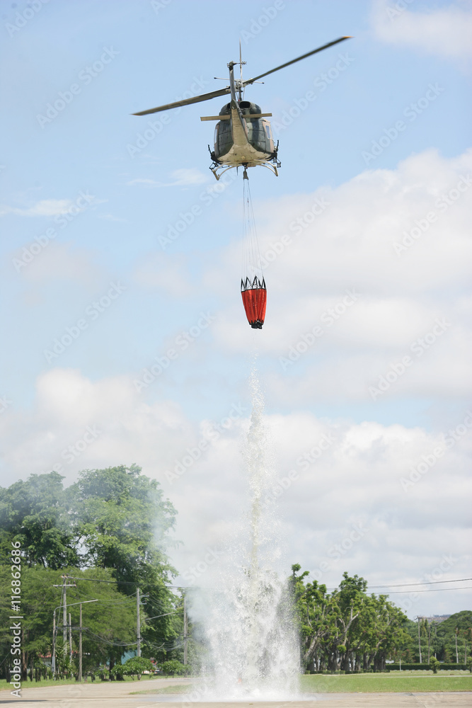 Helicopter dropping massive water from bambi bucket. Helicopter dropping massive water from bambi bucket.