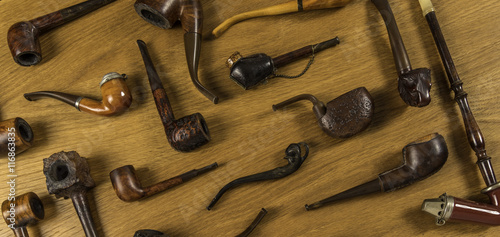 Vintage tobacco pipe set on wooden background