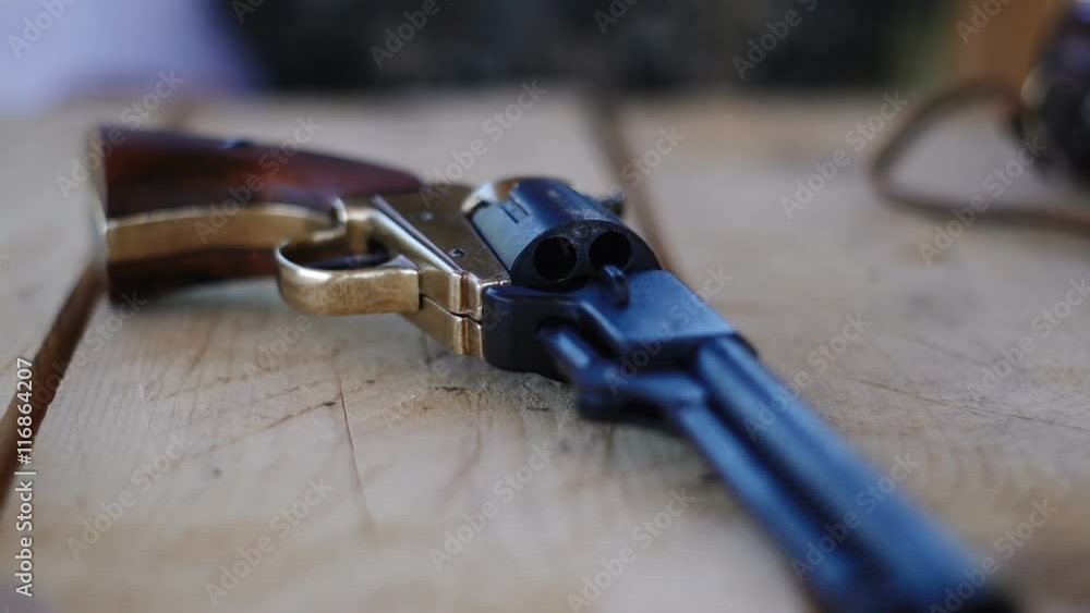 Duplicate of the Colt Peacemaker lying on a wooden table, the legendary American gun during the civil war.
Duplicate of the Colt Peacemaker lying on a wooden table, the legendary American gun during the civil war.