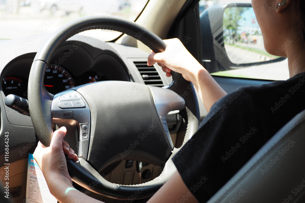 girl is driving car on the road