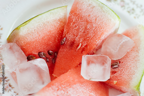 Frozen slices of watermelon on white plate