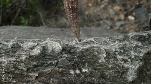 Iron mattock to break the rock into dust
